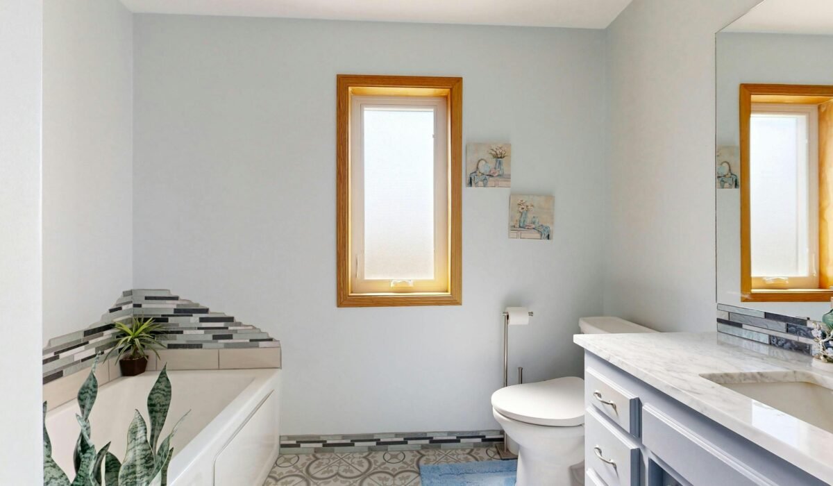 Bright modern bathroom featuring a tub, skylight, and elegant decor. — Photo by Peter Vang on Pexels