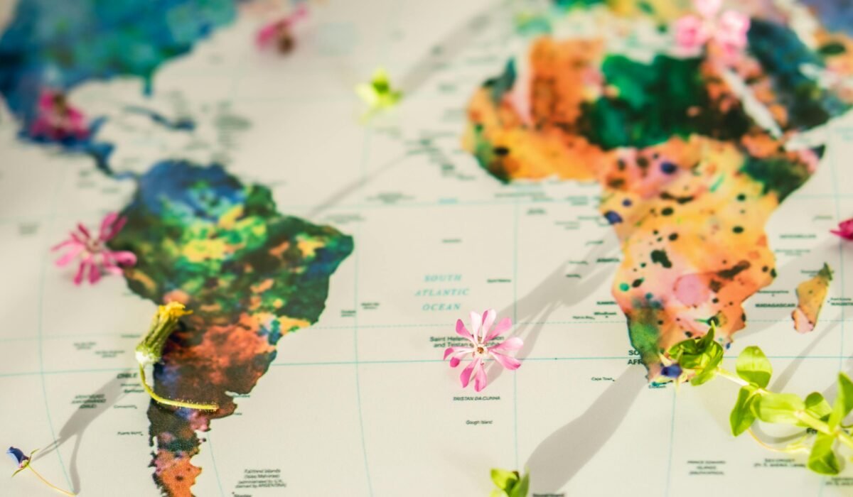 Colorful world map adorned with flowers and green leaves symbolizing global peace and nature. — Photo by Olha Ruskykh on Pexels