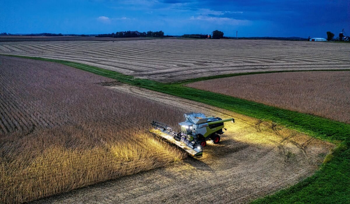 Drone captures a combine harvester working in Minnesota soybean fields at dusk. — Photo by Tom Fisk on Pexels